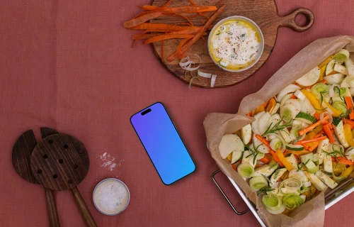 Baking pan full of vegetables and a phone mockup