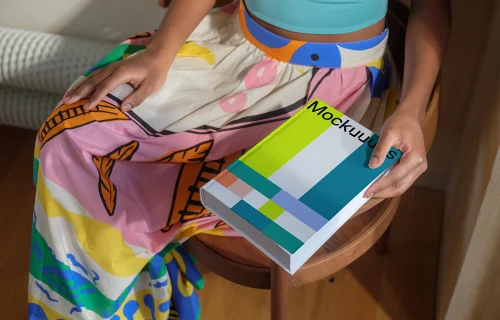 Book mockup held by a person in colorful attire