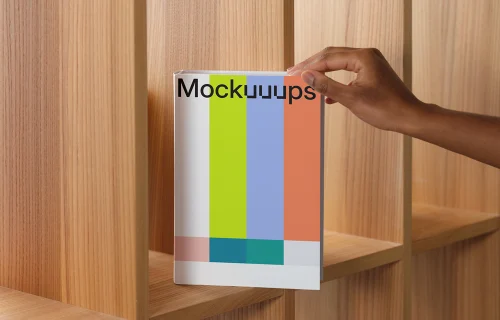 Book mockup on a wooden shelf with hand placement