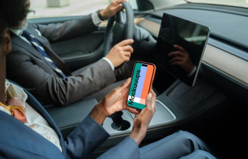 Businesspeople in Tesla with iPhone mockup