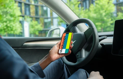 Businesswoman thriving in Tesla with iPhone 14 Pro