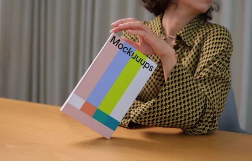 C-format book mockup held in a modern setting