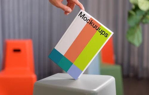 C-format book mockup held over modern stools