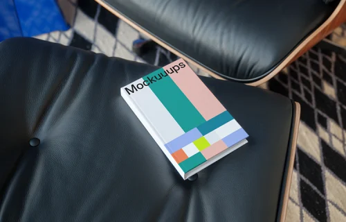 C-format book mockup on a leather chair in a modern setting