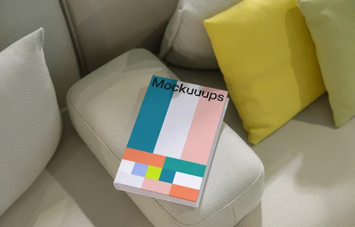 C-format book mockup on a modern sofa with cushions