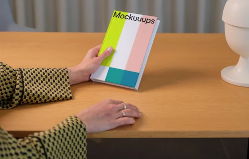 C-format book mockup on a wooden desk