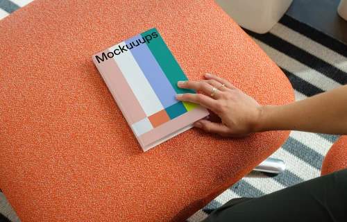 C-format book mockup on an orange ottoman