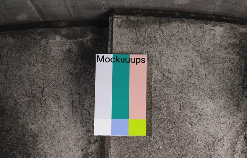C-format book mockup on textured concrete background