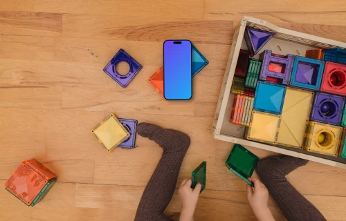 Children's play area mockup with smartphone and colorful toys