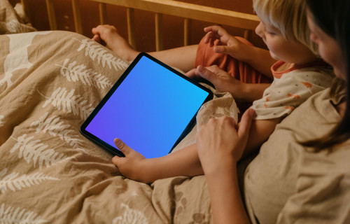 Child's hand holding an iPad Air mockup
