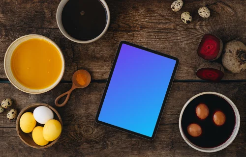 Coloring Easter eggs around tablet mockup