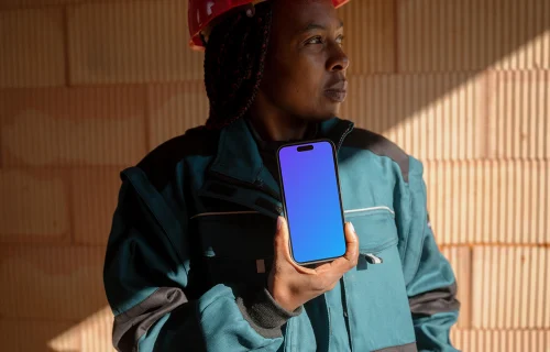 Construction worker presenting an iPhone mockup