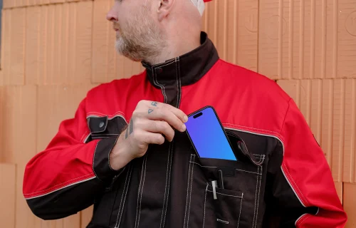Construction worker with a phone in his pocket