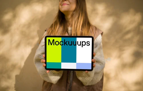 Female in an autumn vest holding an iPad Air mockup