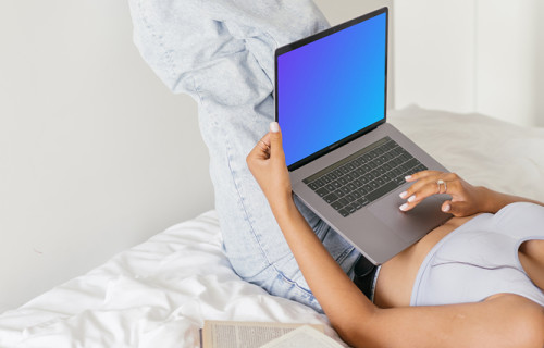 Grey MacBook Air mockup held in a user’s lap