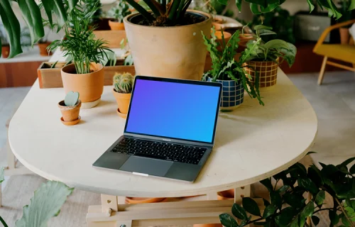 Grey MacBook Pro mockup on a round table