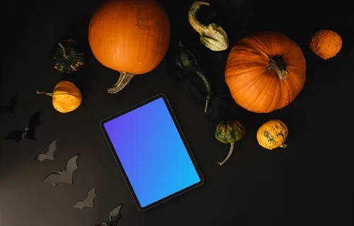 Halloween pumpkin mockup with a tablet on the dark background