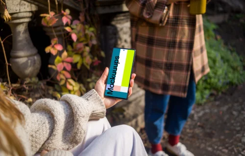 Hand holding a Google Pixel 6 in the park mockup