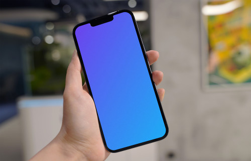 Hand holding an iPhone 13 Pro mockup