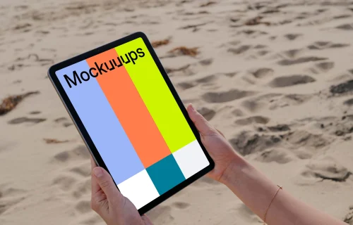 iPad Air mockup held by a user at the beach