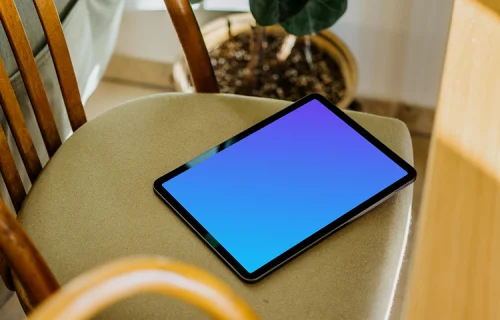 iPad Air mockup on a chair with a plant in the background