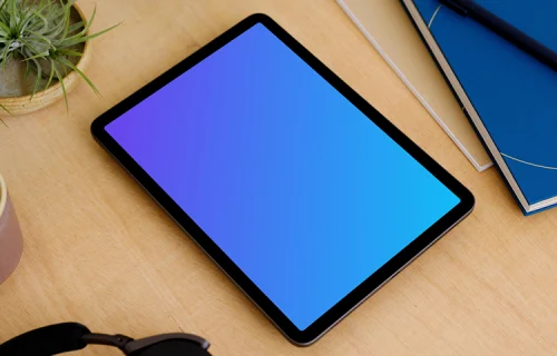 iPad Air mockup on a table beside a diary