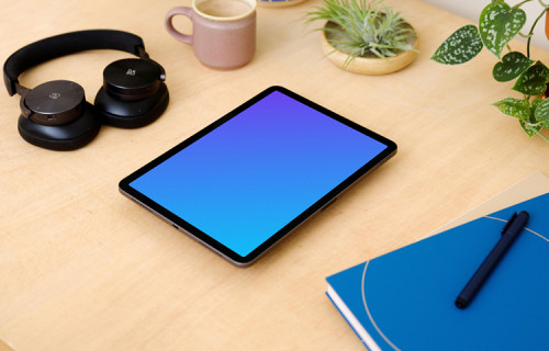 iPad Air mockup on a table surrounded with potted plants