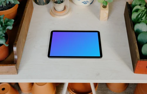 iPad Air mockup on a table with potted plants