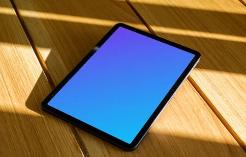 iPad Air mockup on a wooden table in the sunlight