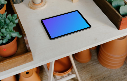 iPad Air mockup surrounded by potted plants on a white table