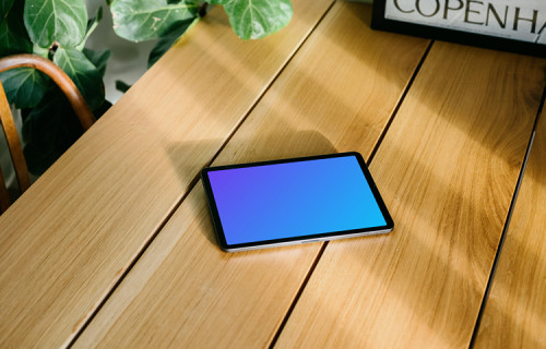 iPad Air mockup with a framed photo in the background
