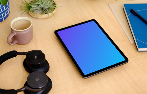  iPad Air mockup with a pair of headphones at the side