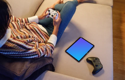 iPad Air mockup with gaming controllers on a sofa