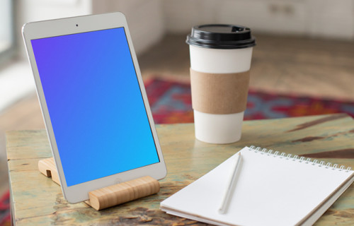 iPad Mini mockup beside a notepad