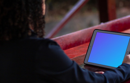 iPad Mini mockup held by female user