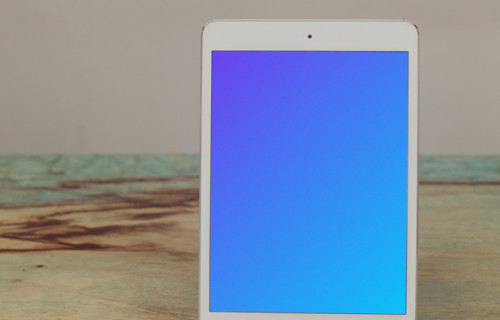 iPad Mini mockup placed on a wooden stand in potrait mode