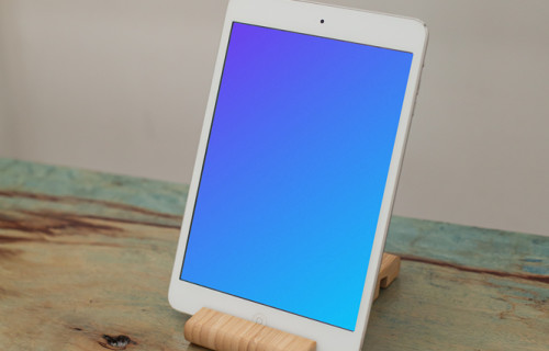 iPad Mini mockup placed on a wooden table in portrait mode