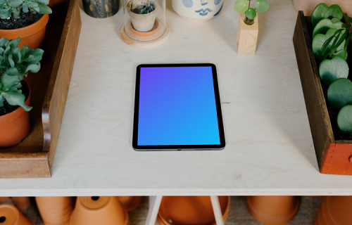 iPad mockup on a white garden table