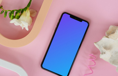 iPhone 12 mockup on a pink table