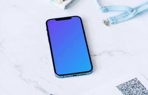 iPhone 12 Pro mockup on a white table beside a bikini