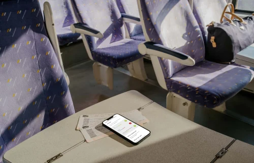 iPhone 13 mockup on table in train 