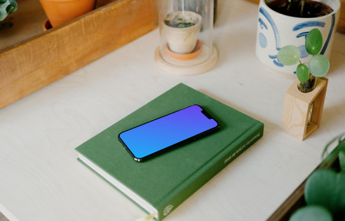 iPhone 13 Pro max mockup on a green notebook