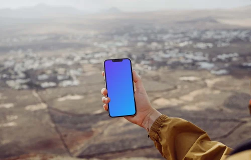 iPhone 13 Pro mockup held by a user above a field