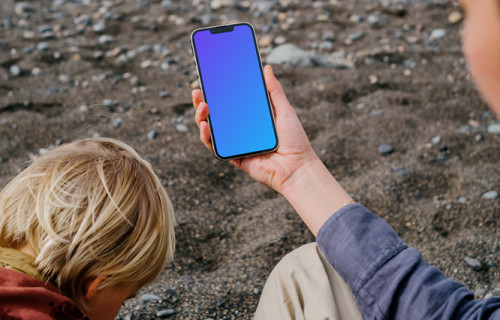 iPhone 13 Pro mockup held by a user at the beach