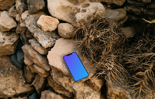 iPhone 13 Pro mockup on stacked rocks