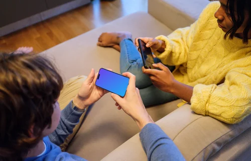 iPhone 15 Pro handheld mockup in a casual gaming setting