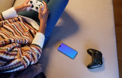 iPhone 15 Pro mockup beside gaming controls