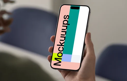 iPhone 15 Pro mockup in hand against blurred background
