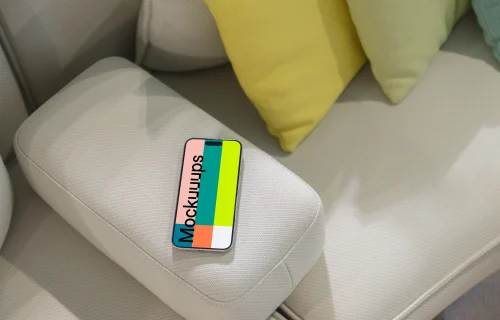 iPhone 15 Pro mockup on modern couch with colorful cushions