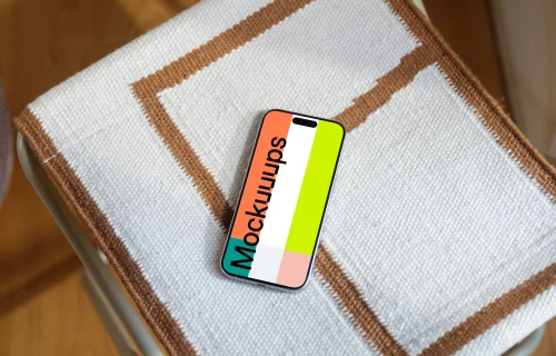 iPhone 15 Pro mockup on textured fabric chair